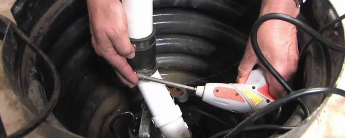 Sump pump installation technician connecting PVC discharge piping in Arlington, TX